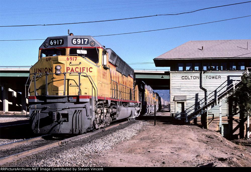 UP 6917 west crosses the SP at Colton tower,